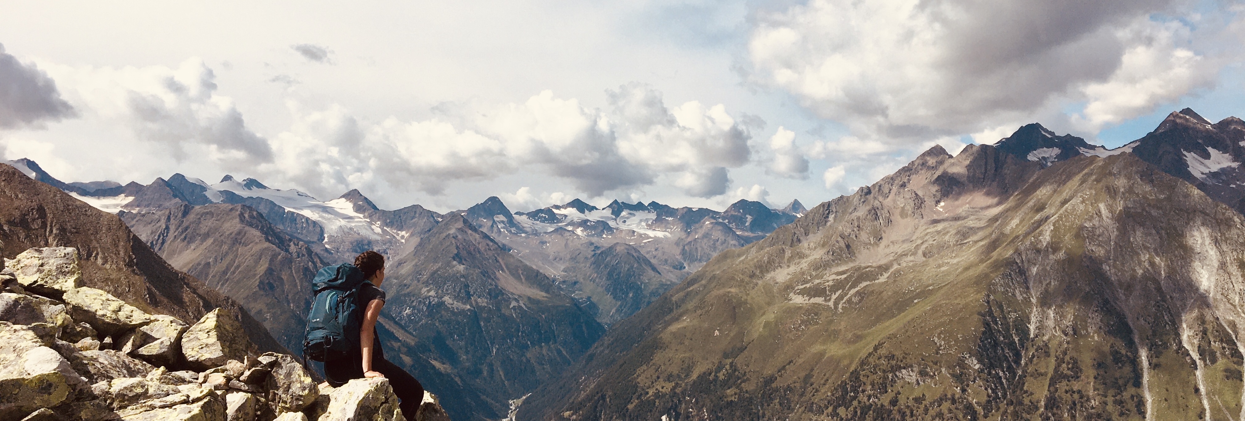 Mountain landscape with ridges and clouds.